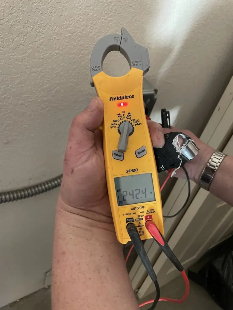 Voltage testing with clamp meter during Outlet Installation in Cheshire